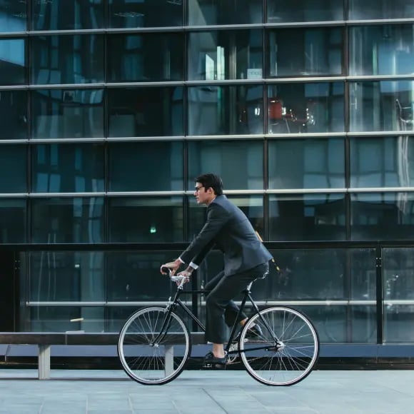 handsome-young-business-man-with-his-modern-bicycle 1